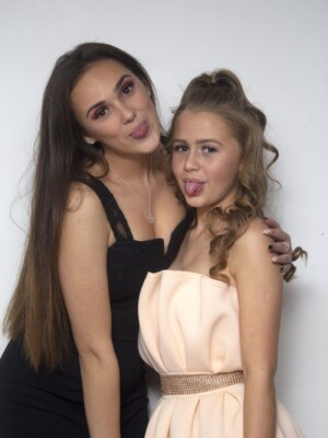 A well shot photo of two girls sticking their tongues out.