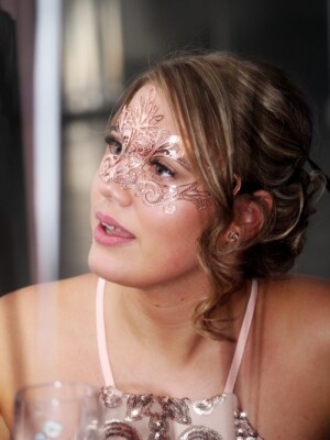 A well shot photo of a girl with a mask on.