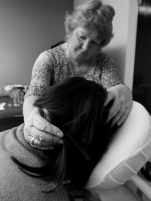 An image of a woman holding another woman's head