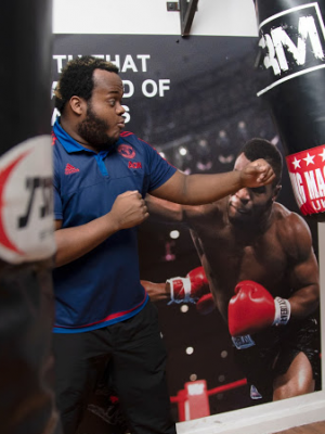 A well shot photo of a man punching a punching bag