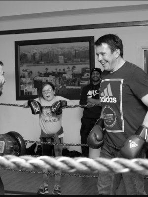 A well shot photo of two men in a boxing ring laughing